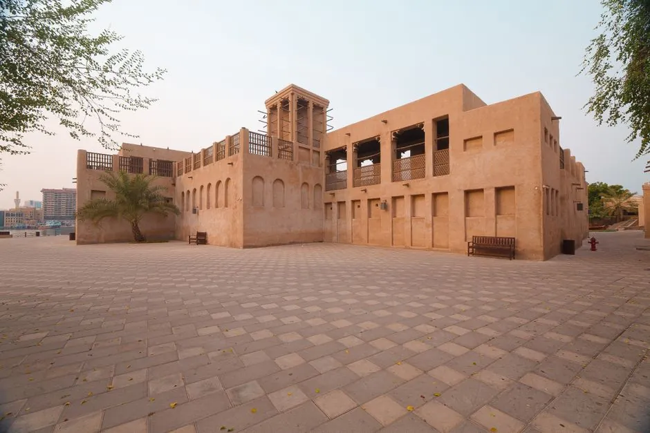 Wind-tower houses and a paved square in the Al Fahidi historical district, old Bur Dubai, a few minutes from Al Mankhool