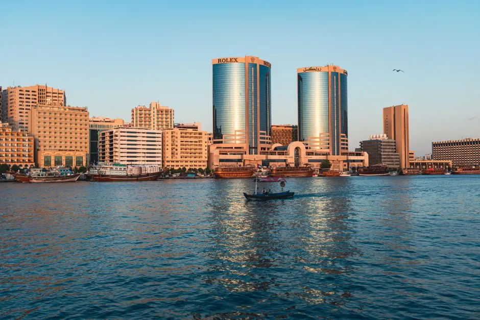 Deira's Creek waterfront with the Deira Twin Towers and a wooden abra crossing the water