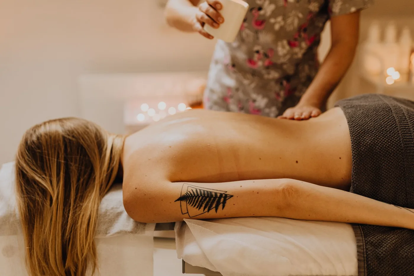Massage oil being warmed between hands before a session