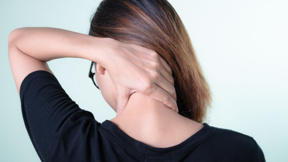 A woman rubbing her neck to ease desk and screen tension